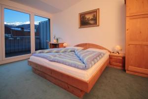 Tempat tidur dalam kamar di Pension & Residence Astoria