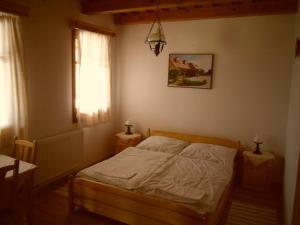 A bed or beds in a room at Nosztalgia Vendégház