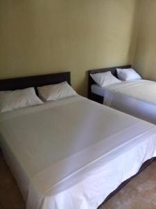 Postel nebo postele na pokoji v ubytování Syifa Homestay