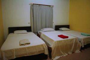 Postel nebo postele na pokoji v ubytování Syifa Homestay