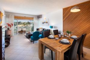 a dining room and living room with a table and chairs at Sea View Downtown - Albufeira in Albufeira