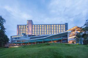 a large building with a hill in front of it at Swiss-Belresort Dago Heritage in Bandung