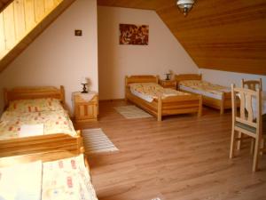 A bed or beds in a room at Nosztalgia Vendégház