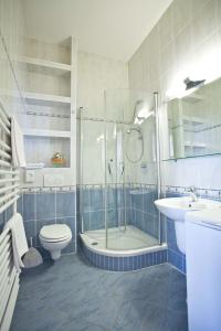 a bathroom with a shower and a toilet and a sink at Studio Apartmani Bijeli Delfin in Biograd na Moru +31 photos