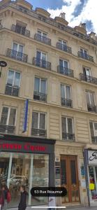 a large building on a street with people walking in front at RESIDENCE MONTORGUEIL in Paris