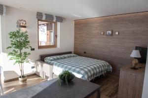 a bedroom with a bed and a table in it at Chalet Bello in Livigno