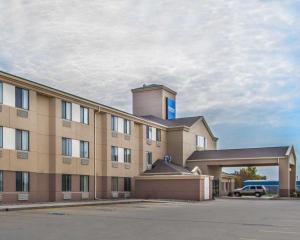 a building with a parking lot in front of it at Rodeway Inn in Fremont