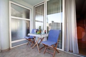 a table and two chairs in front of a window at Studio Apartmani Bijeli Delfin in Biograd na Moru
