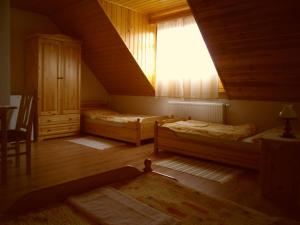 A bed or beds in a room at Nosztalgia Vendégház