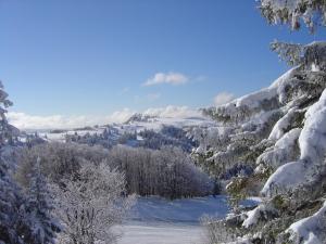 a view of a snow covered valley with trees at Azureva Métabief in Métabief