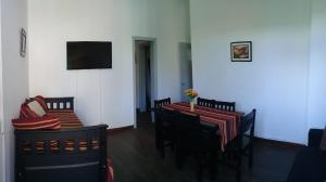 a dining room with a table and chairs and a television at Colonial Belgrano in San Salvador de Jujuy
