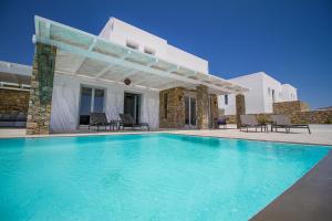 a swimming pool in front of a villa at Villa ANAIS 2 MYKONOS in Elia Beach