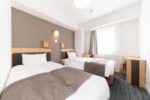 Postel nebo postele na pokoji v ubytování Pearl Hotel Shinjuku Akebonobashi