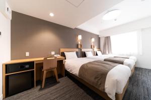 Postel nebo postele na pokoji v ubytování Pearl Hotel Shinjuku Akebonobashi