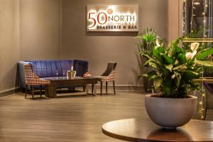 a lobby with a blue couch and chairs and a table at Copthorne Hotel Plymouth in Plymouth +56 photos