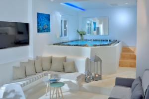 a living room with a couch and a tub at Elegant Mykonos in Mikonos