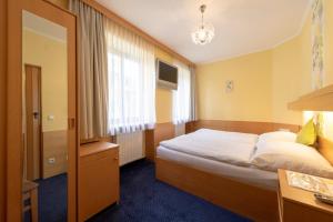 Postel nebo postele na pokoji v ubytování Pension Wienerstub'n