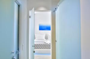 a bedroom with a bed and a mirror at Elegant Mykonos in Mýkonos City