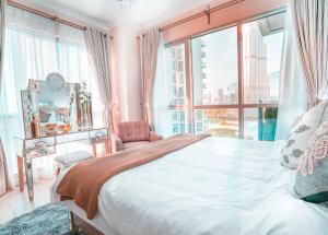 a bedroom with a large bed and a large window at Elite Royal Apartment | Burj Residences Tower 5 | Gold in Dubai