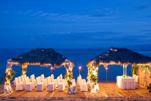 a wedding reception on the beach at night at Princess Resort, Santikos Collection in Agia Paraskevi