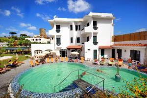 a large swimming pool in front of a building at Hotel Park Victoria in Ischia