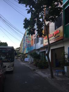 um autocarro a descer uma rua ao lado de um edifício em Khánh Vân - VT Cloud mini Hotel em Vung Tau