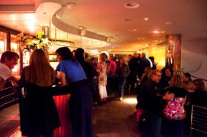 a crowd of people standing around a bar in a store at Hotel Rival in Stockholm