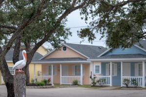 a house with a pelican statue in front of it at D&R Pelican Bay Resort in Rockport