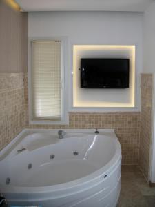 A television and/or entertainment centre at Rhapsody Hotel Kas
