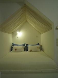 a white bed with a canopy in a bedroom at Palemilos Apartments in Elounda
