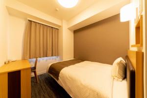 Postel nebo postele na pokoji v ubytování Pearl Hotel Shinjuku Akebonobashi
