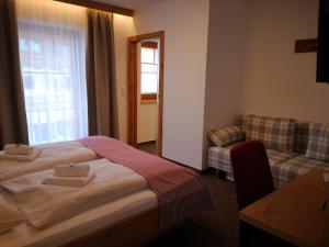 Postel nebo postele na pokoji v ubytování Hotel Aschauer Hof z'Fritzn