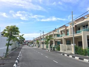 an empty street with a row of apartment buildings at 92 Home Sleep Home Kuah Langkawi in Kuah