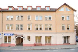 a large building on the corner of a street at Hotel Thüringer Hof in Jena