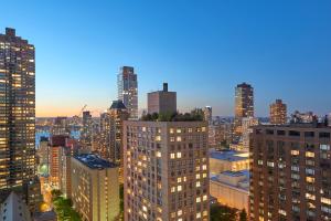a city skyline at night with tall buildings at Mandarin Oriental New York in New York