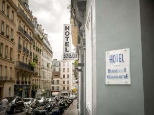 a sign for a hotel on the side of a building at Bonséjour Montmartre in Paris +26 photos