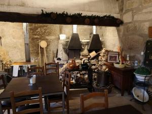 a dining room with a table and a stove at Quinta do Mosteiro in Felgueiras