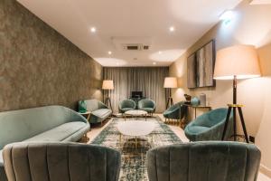 a waiting room with couches and chairs and a table at Rossio Boutique Hotel in Lisbon