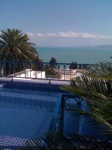 a swimming pool with a view of the ocean at Dar Fatma in Sidi Bou Saïd