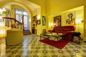 a living room filled with furniture and a red carpet at Albergo Etruria in Volterra
