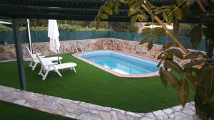 una piscina con una silla, una mesa y un columpio en Villa Vista Dorada 134 Terraza y Piscina Privada Maspalomas, en San Bartolomé