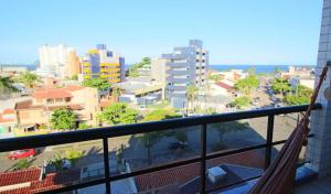 a balcony with a view of a city at Cobertura Duplex perto do mar, piscina, linda vista, 03 garagens, churrasqueira in Guaratuba