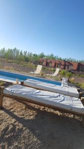 a mattress bed sitting next to a swimming pool at Hotel boutique Pukarainca in Uspallata