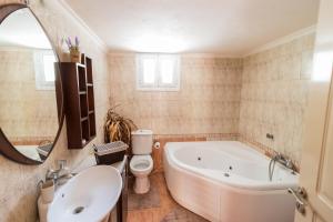 a bathroom with a tub and a toilet and a sink at Traditional Fishing Village Apartments in Boukari +40 photos