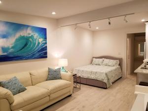 a living room with a couch and a bed at Ocean Vista Resort in Amagansett