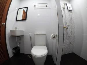 a small bathroom with a toilet and a sink at The Ghee House in Chiang Mai +8 photos