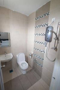 a bathroom with a toilet and a sink at KompoVilla in Kuantan