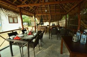 a dining room with a table and chairs in a building at The Araliya Retreat in Kalpitiya