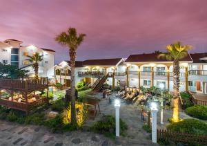 an exterior view of a resort with palm trees at Grim Resort in Jeju