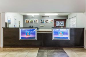 a waiting area at a hospital with three televisions at Motel 6-Alexandria, LA - South in Alexandria +27 photos